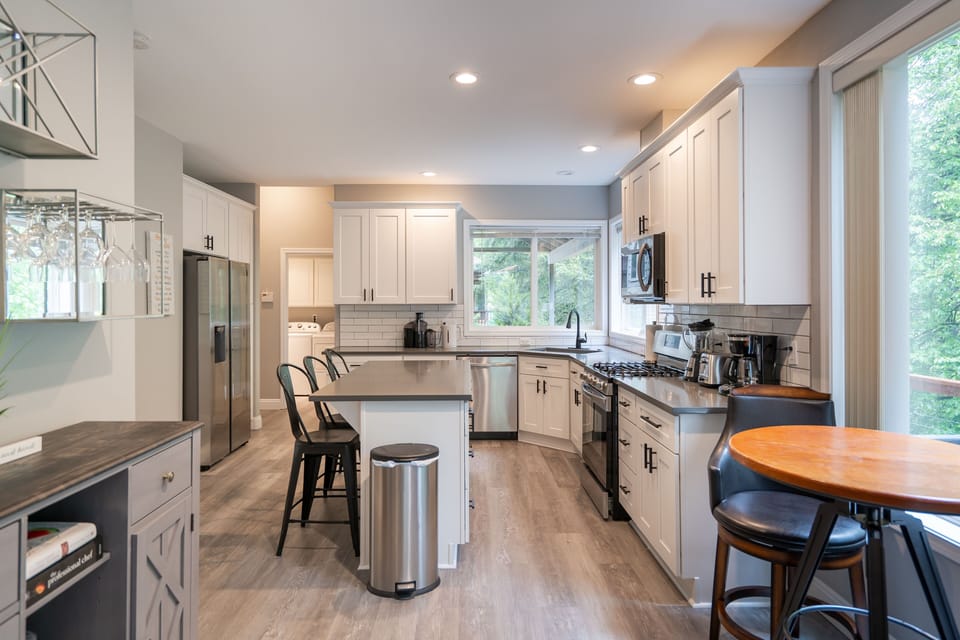 Kitchen with island, pub table and bar counter