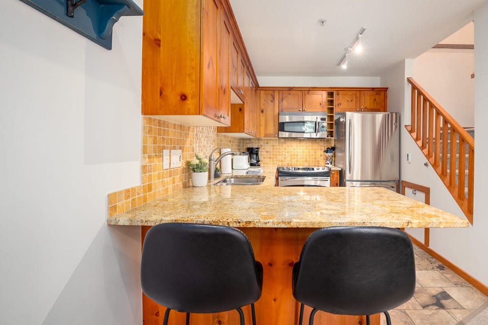 The sleek breakfast bar is perfect for quick meals or socializing over coffee.