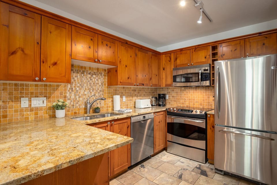 Cook with ease in a fully equipped kitchen with stainless steel appliances.