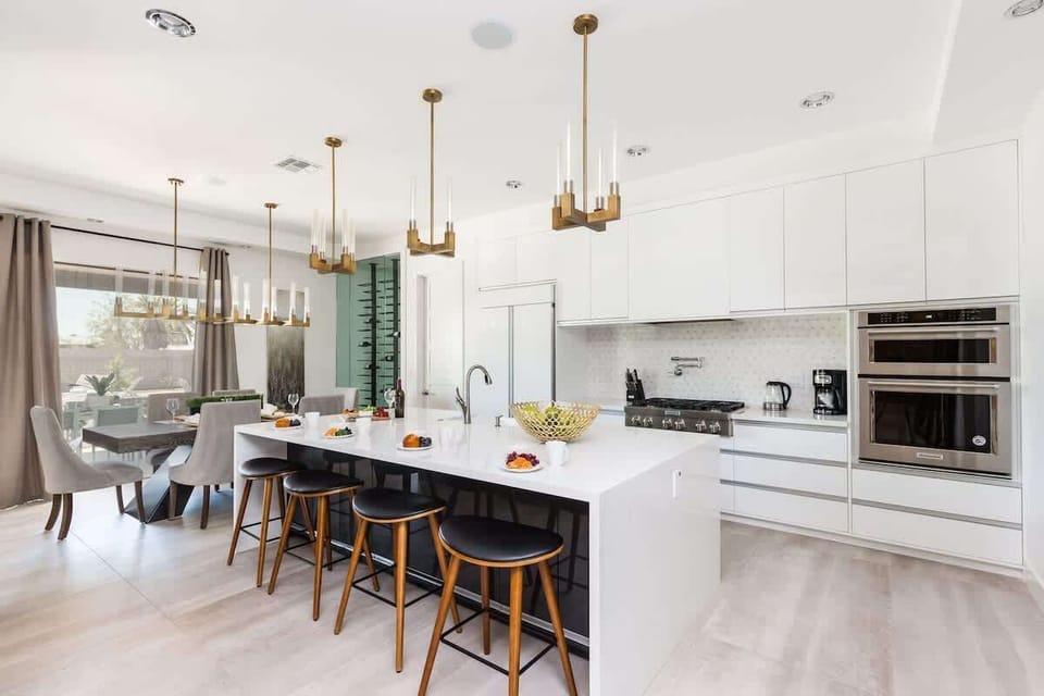 Fully Equipped Chefs Kitchen stocked with all culinary essentials, and stainless steel appliances. Features an oversized island with breakfast bar seating.