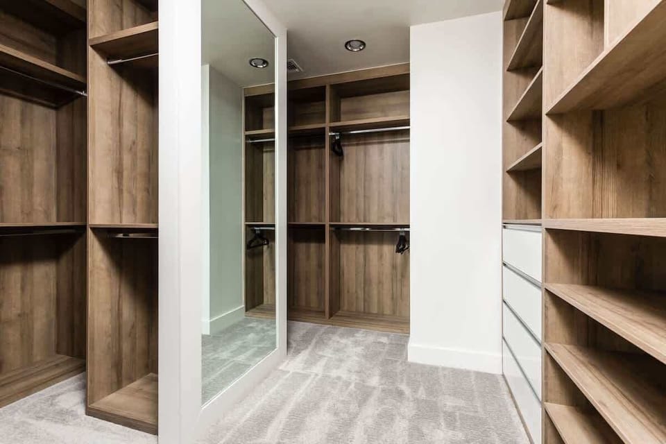 Large Primary Closet with built in shelving.