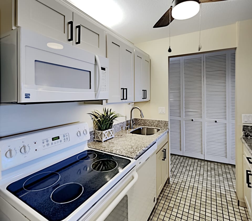Enjoy a homecooked meal with everything you could need supplied in the condo kitchen.