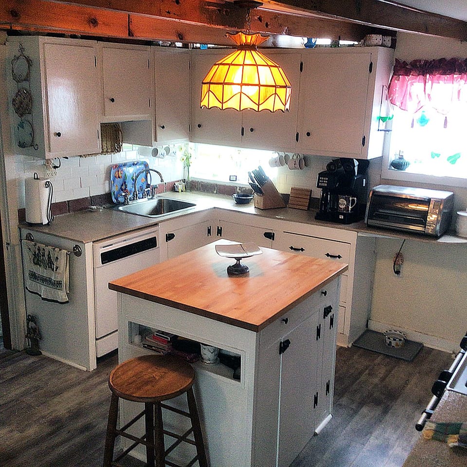 Kitchen with island. It does not show, but a sweet stain glass window near sink.