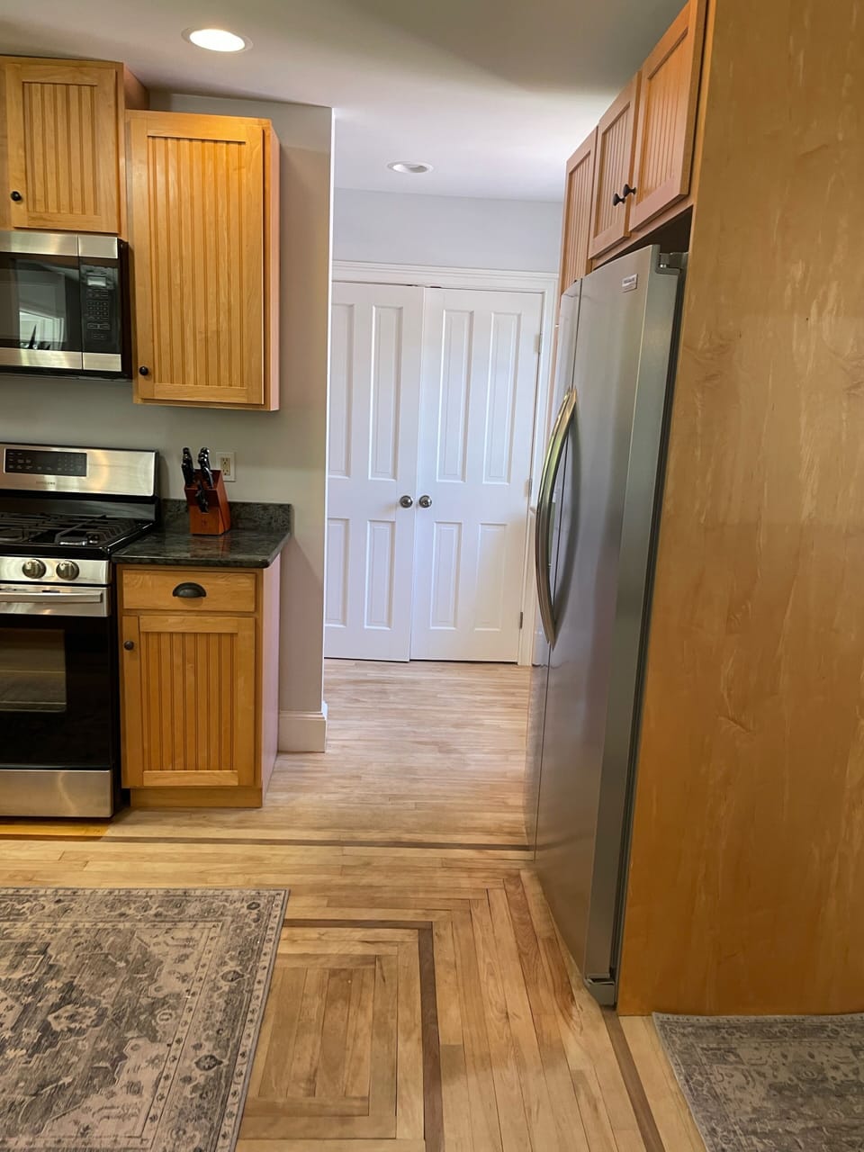 Large pantry closet, window seat and half bath tucked behind the kitchen. 