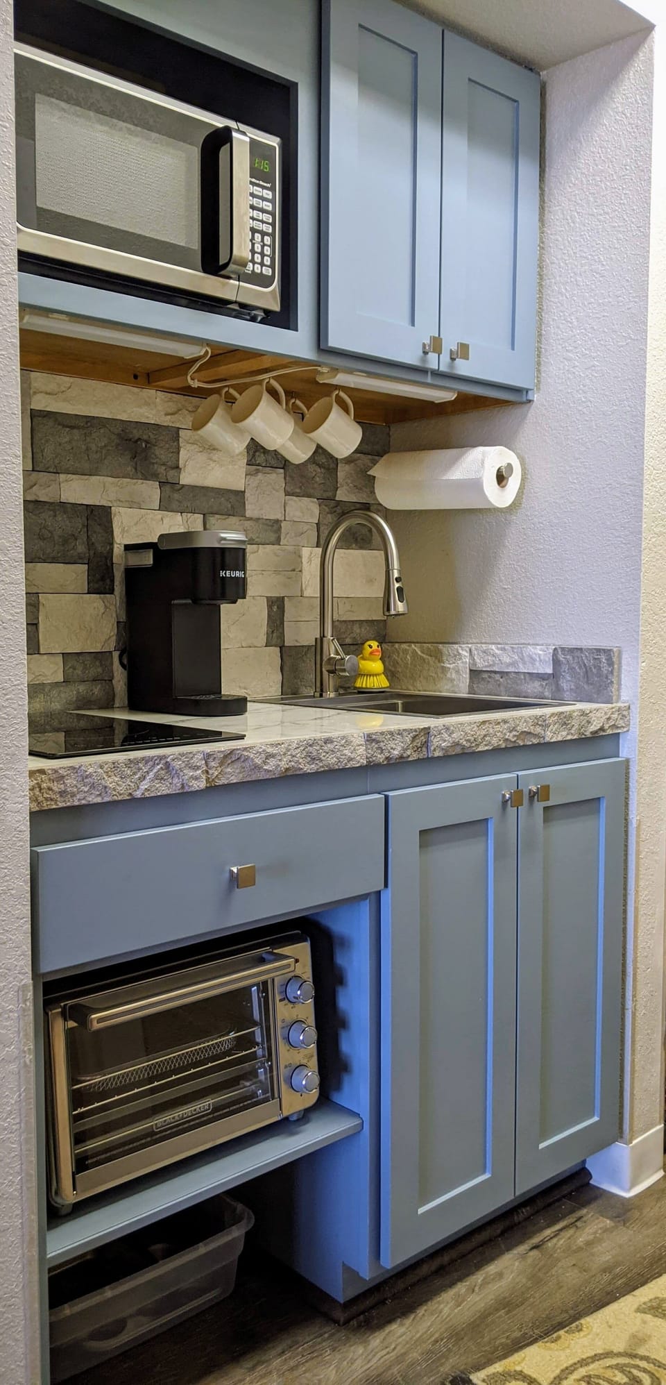 Kitchenette with microwave and toaster oven.
