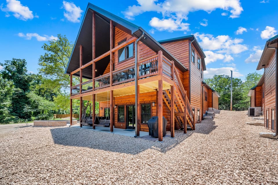 Back view.  Firepit, private hot tub, propane grill, and swings will make this your dream vacation spot