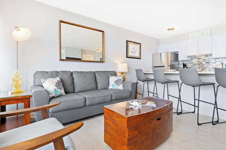 The living area has a pull-out sleeper sofa, chair, and a coffee table!