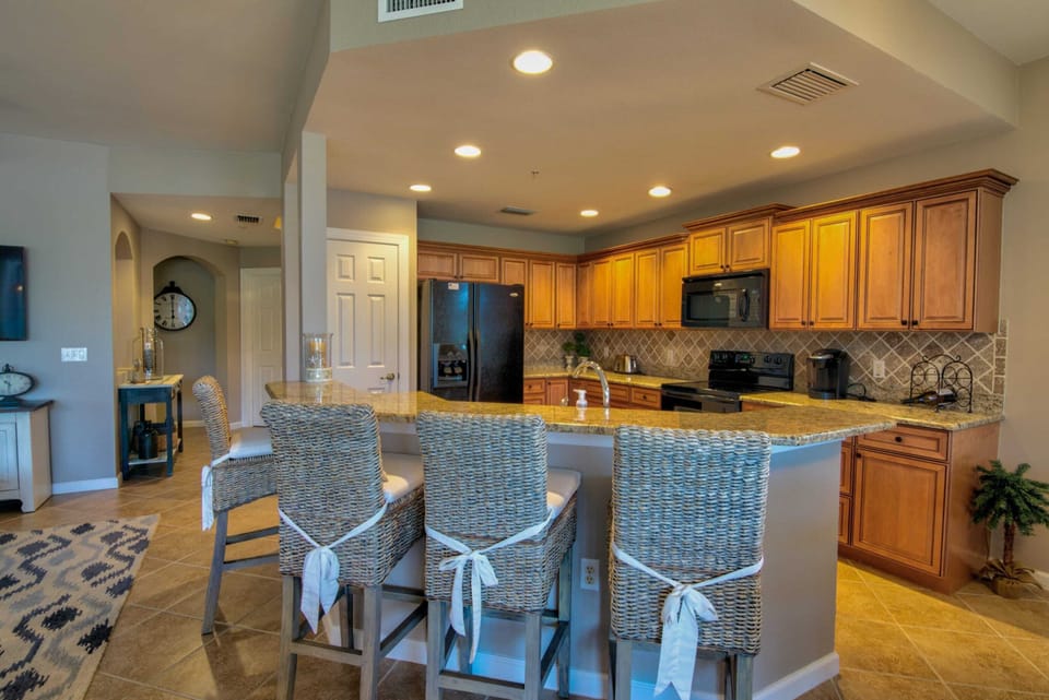 There is Granite Counters a A Bar Height Counter in the Kitchen