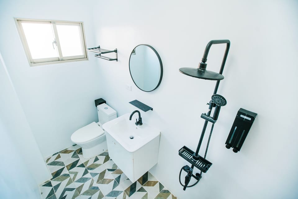 Deluxe Quadruple Room | Bathroom | Shower, hair dryer, slippers, towels