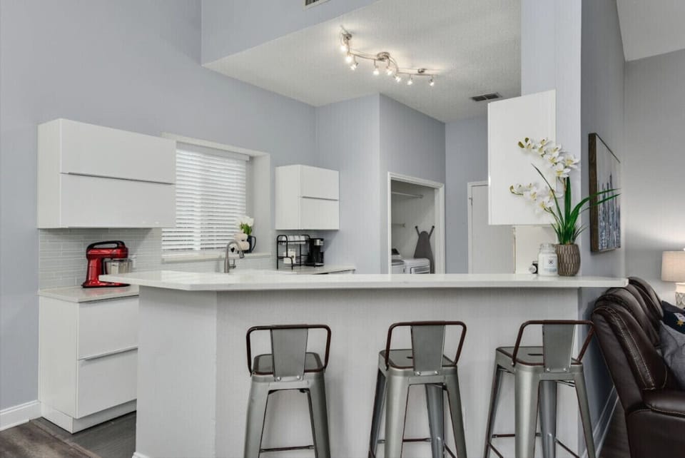 Gather around the spacious kitchen island, perfect for enjoying meals or sharing stories over coffee.