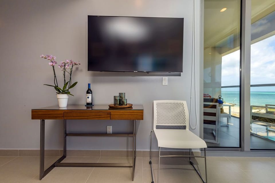 Unwind in your private living area with ocean views and modern amenities. Watch your favorite shows, pour a glass of wine, and step out to your terrace whenever you please.
