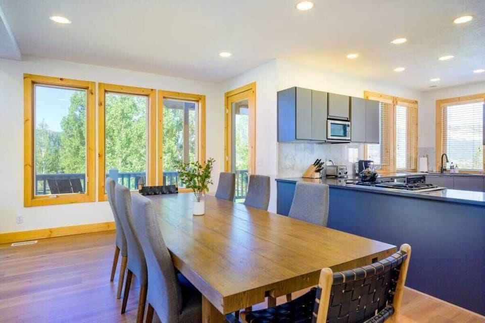 The open-concept living space, complete with a dining area, facilitates effortless conversation with family and friends.