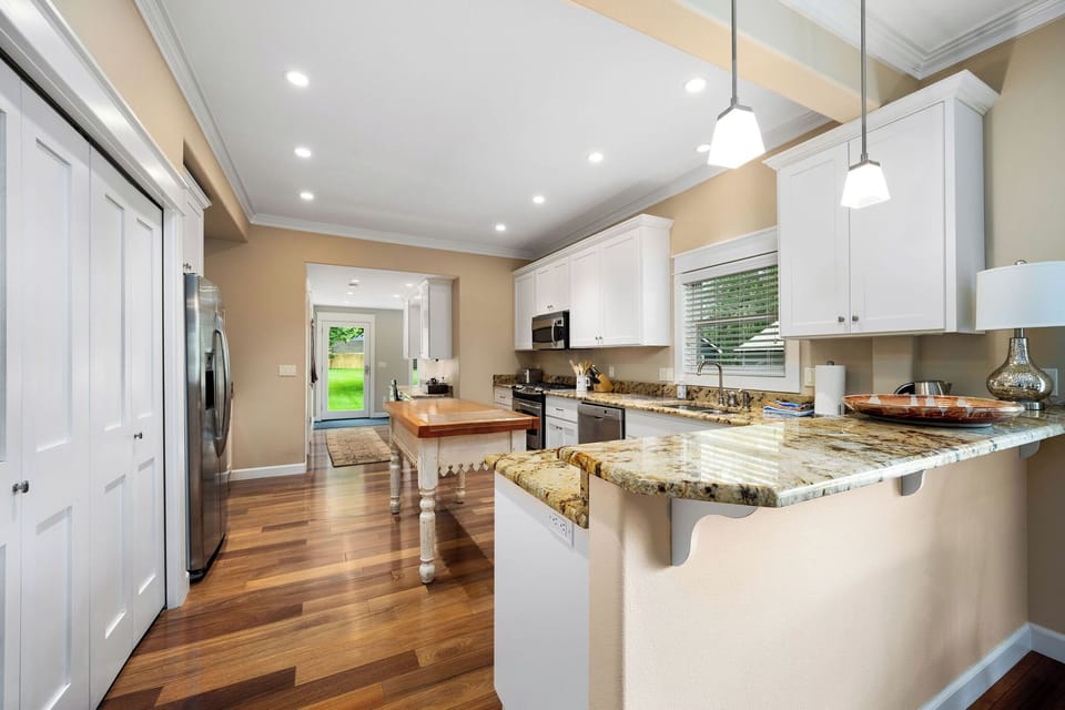 Your chef's kitchen awaits with granite counters, modern appliances, and warm hardwood floors for memorable meal prep.