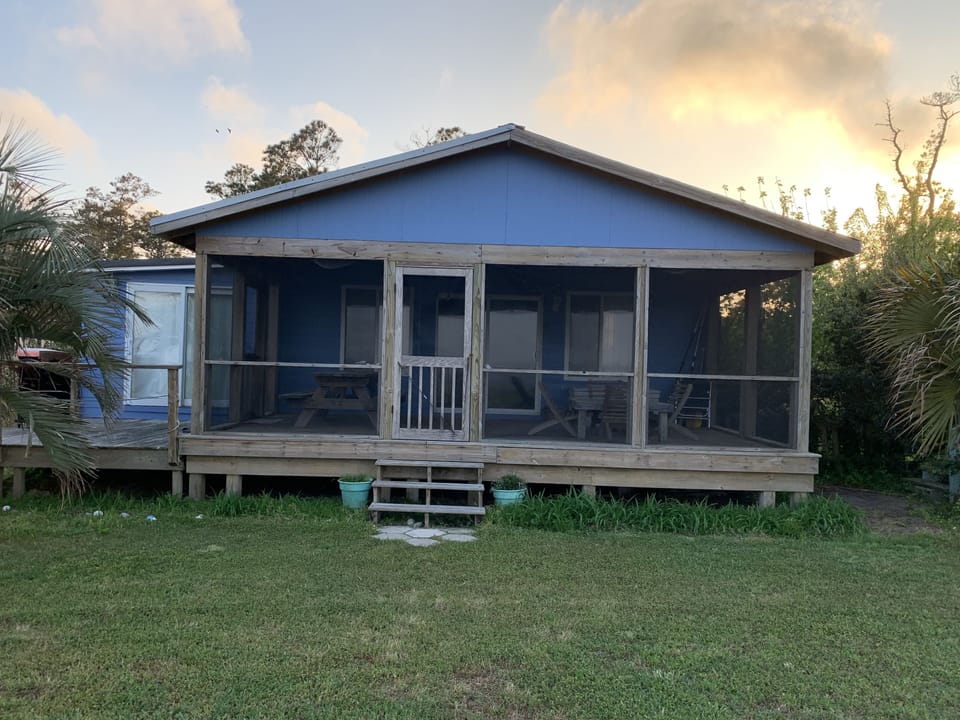 Front screened porch faces out to Cedar Island Bay.