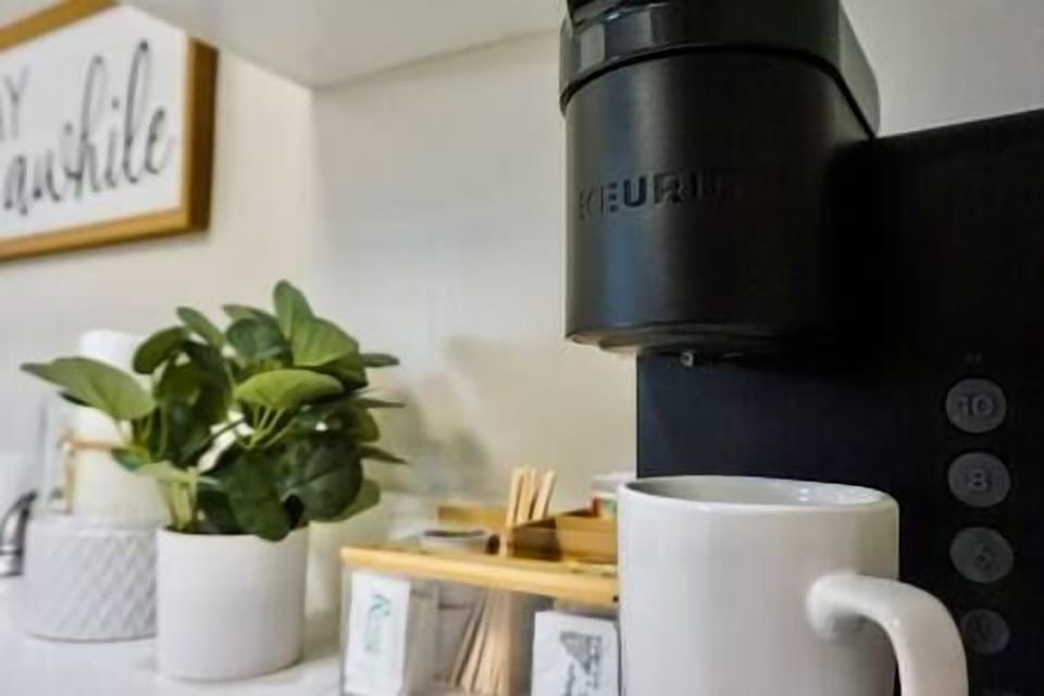 Keurig Coffee Machine with complimentary coffee pods, tea, sugar, & creamers