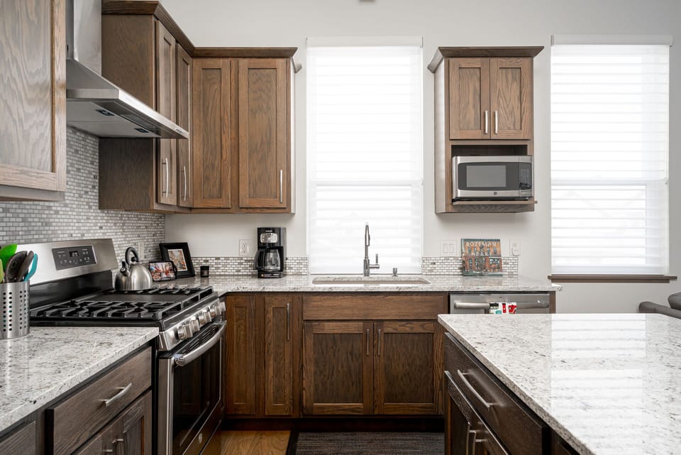 Kitchen island offers additional cooking space and bar seats for dining.