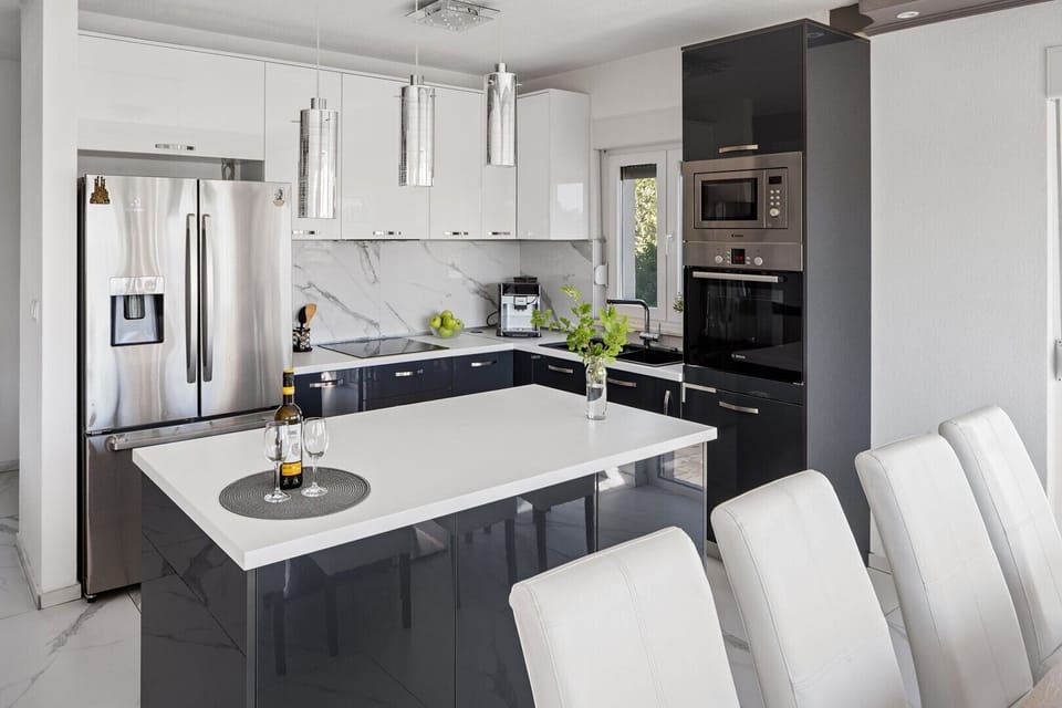 The modern kitchen contains such cooler, microwave, coffee maker, toaster, and kettle.