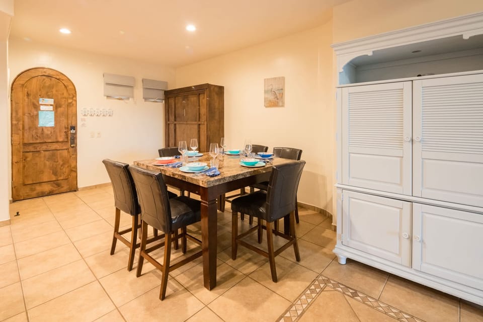 Enjoy meals together in this cozy dining space featuring rustic wood finishes and warm lighting.