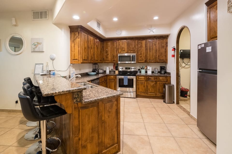 Bar stools provide additional space for casual dining or morning coffee.