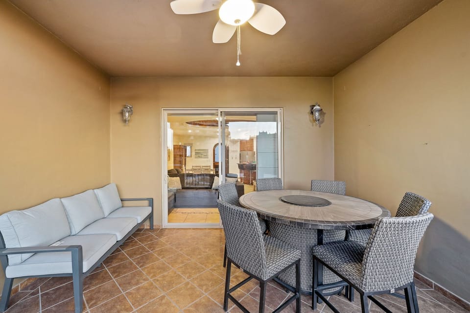 Outdoor dining and lounge area on the covered balcony perfect for meals, games, or relaxing in the shade.