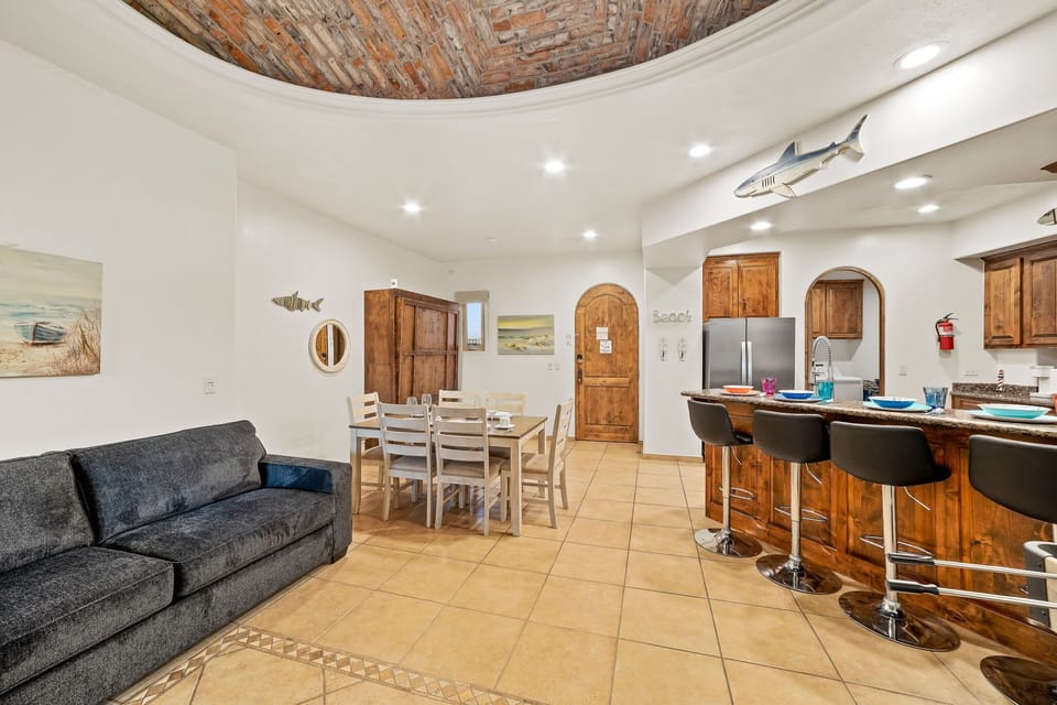 Open kitchen and dining area with bar seating perfect for casual meals, entertaining, or enjoying a morning coffee.