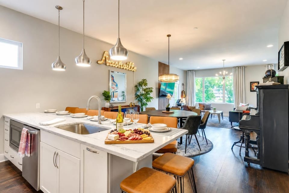 Open-concept kitchen with island seating flows right into dining and living areas so the cook isn't left alone, everyone stays in the same room talking and eating together