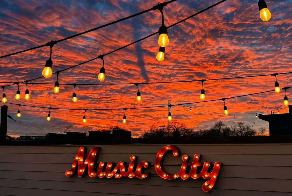The Music City sign glows as strings of light catch the last of the sunset, this is where Nashville trips actually happen