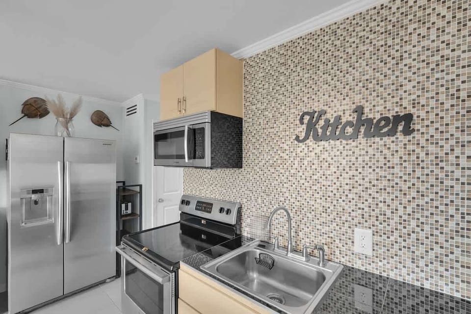 A close-up of the kitchen counter showing the sink and coffee maker area.