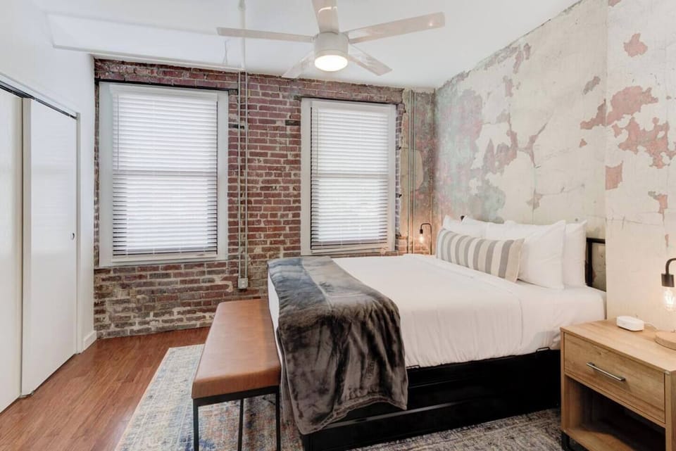 Bedside tables that are handy for trinkets and knick-knacks to keep your bedroom organized, a foot bench that gives you a comfy spot to tie your shoes, and a ceiling fan to make the room cooler.