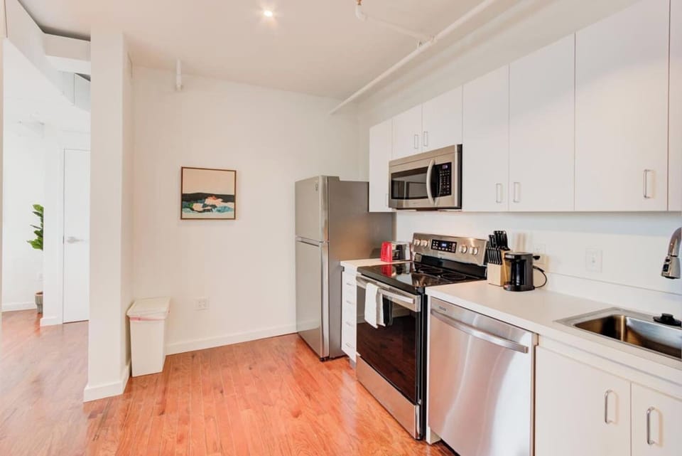 View from the bathroom door to the spacious living space,  we have an ideal size refrigerator for storing cold beverages and takeout or leftover food.