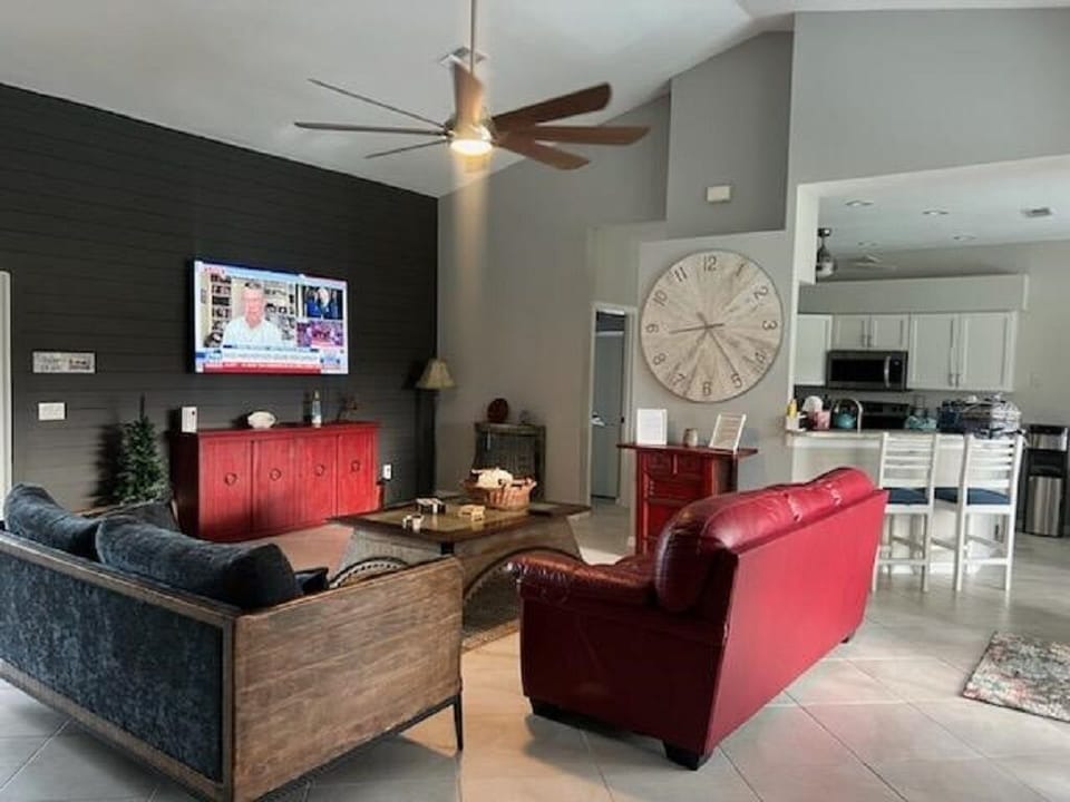 Living room- two couches, smart TV and ceiling fans