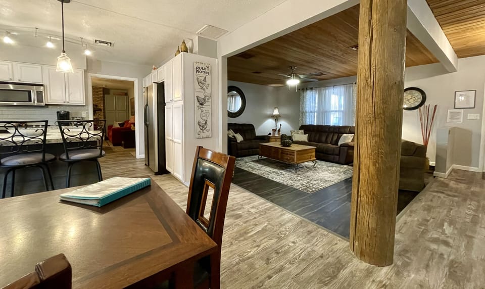 open floor plan with step down, inviting living room & separate den off kitchen