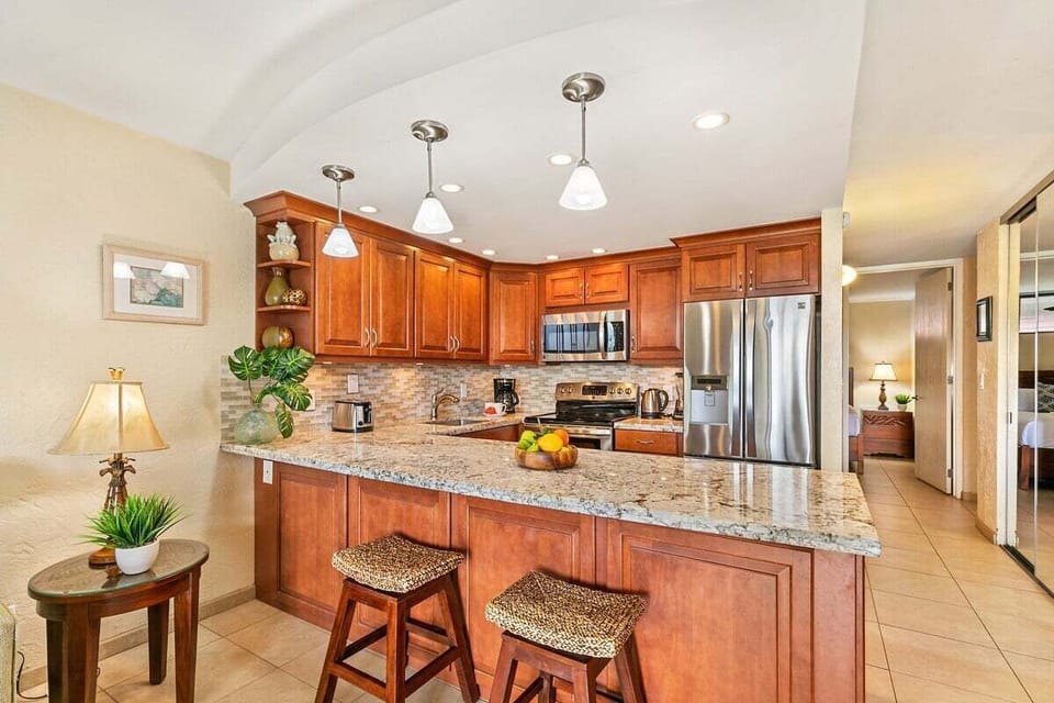 Cook in a modern kitchen with granite and steel.