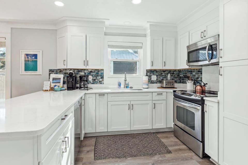 The kitchen is fully stocked with cooking and dining supplies.