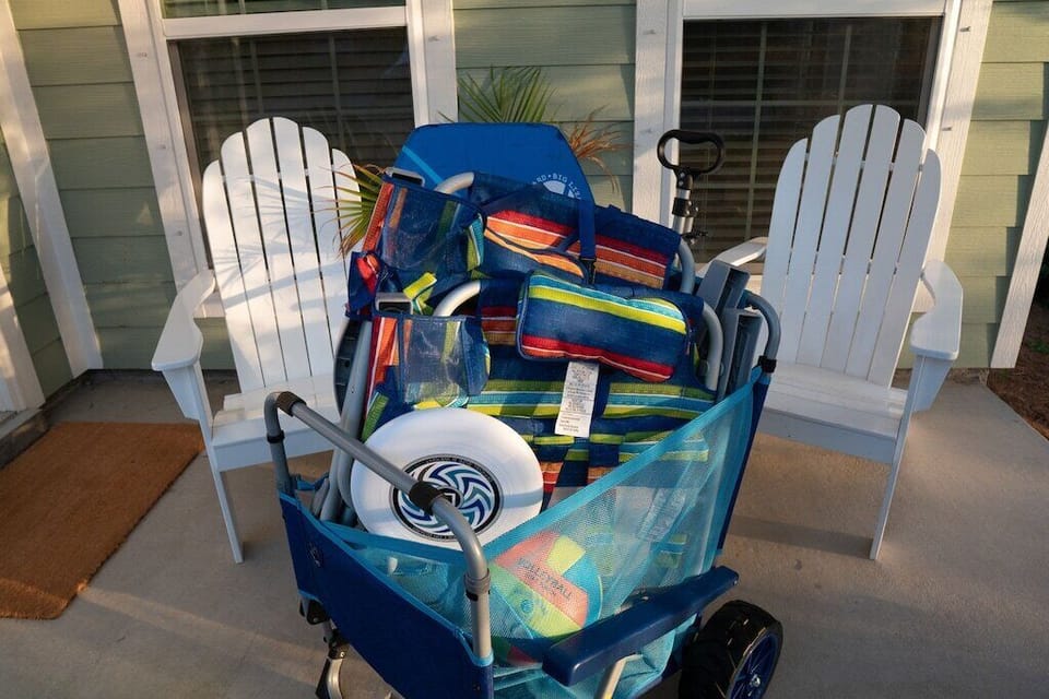Beach cart includes 2 beach chairs, a body board, a volleyball and frisbee