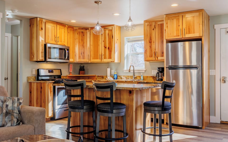 Granite topped breakfast bar in the spacious kitchen is a great place to plan the day's adventures