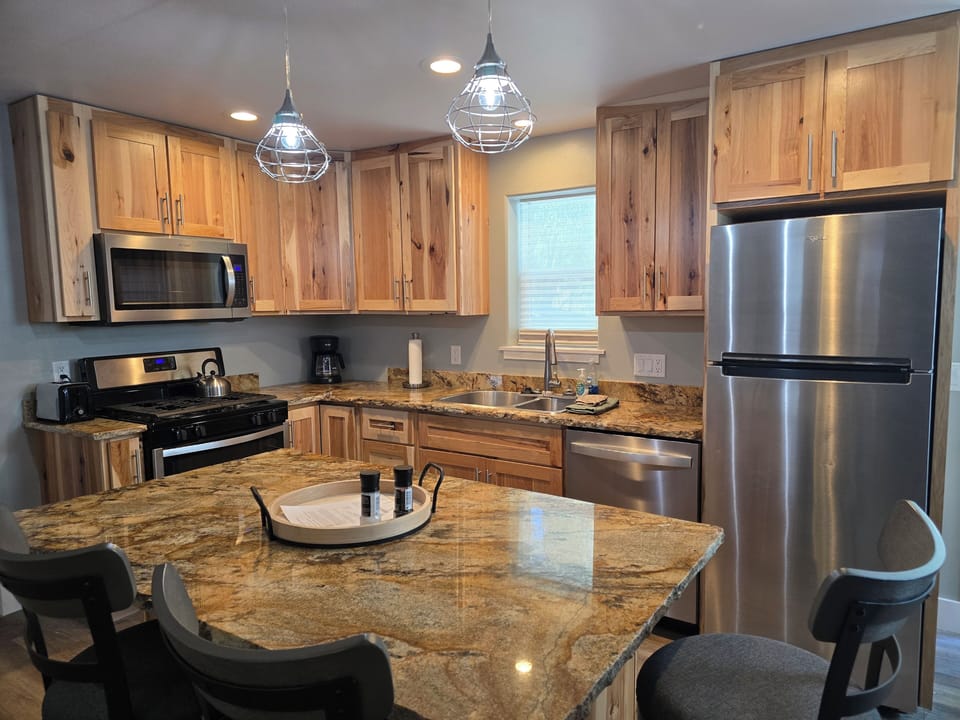 Granite topped breakfast bar in the spacious kitchen is a great place to plan the day's adventures
