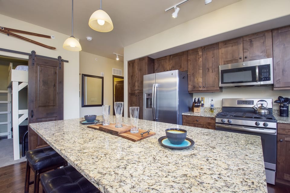 Your gourmet kitchen features granite countertops, rustic wood cabinets, and stainless steel appliances—perfect for creating memorable meals together.