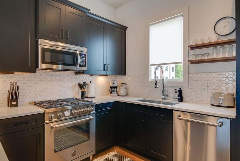 Modern appliances add a beautiful and efficient touch to this high-ceiling, open kitchen.