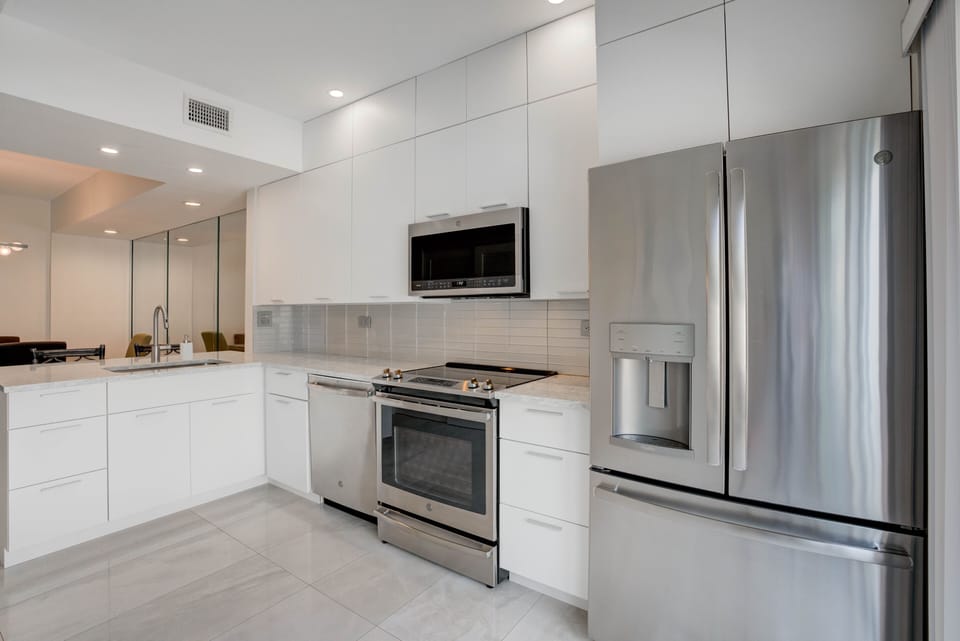 Kitchen view to breakfast bar that has to counter height stools