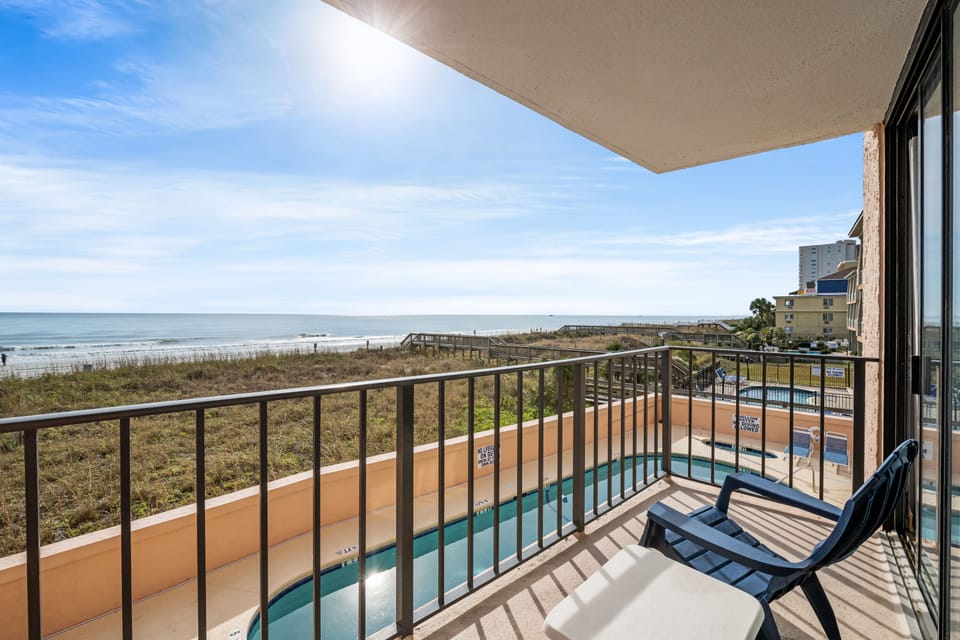Sit outside and relax on this ocean view balcony and listen to the waves.