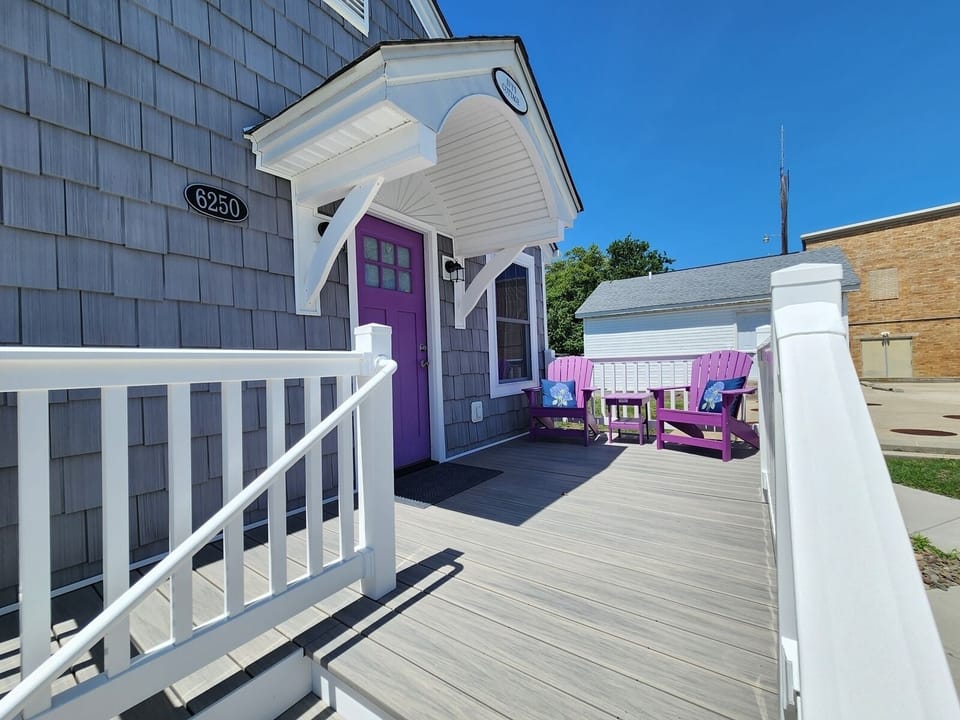 Relax on the charming front porch with Adirondack chairs, perfect for morning coffee or winding down in the evening.