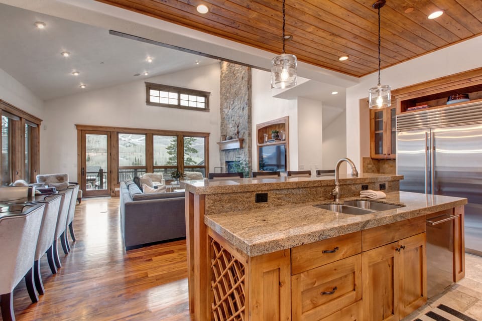 Gourmet Kitchen with granite countertops, Sub-Zero fridge, stainless steel Wolff appliances, bar seating for four, and wine fridge