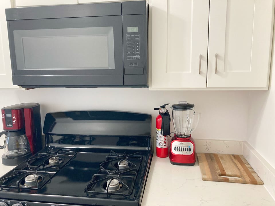 Fire Extinguisher, blender, cutting board 