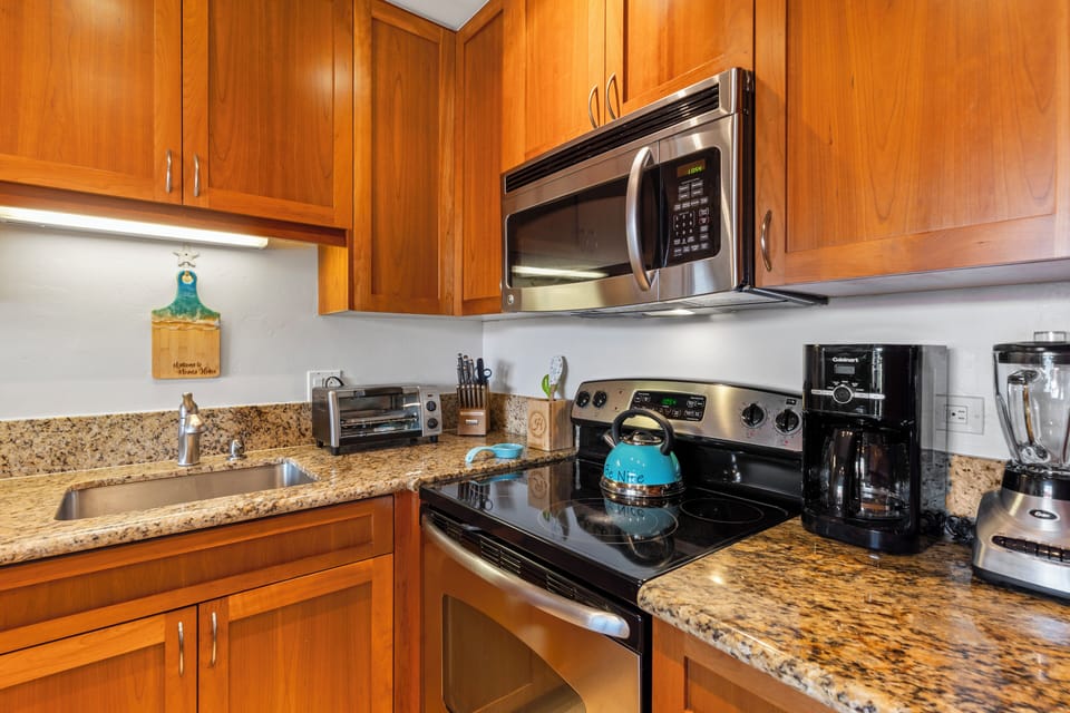 Kitchen is fully stocked with appliances, cooking and serving items and spices