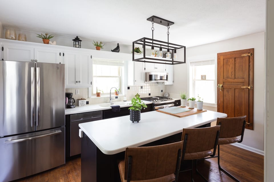 Kitchen w/ propane stove, dishwasher, garbage disposal, fridge w/ ice maker. 