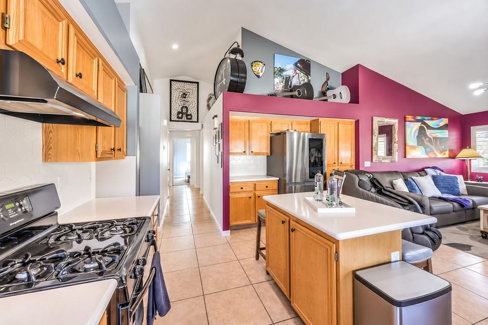 Bright open kitchen and living area with island, vaulted ceilings, and bold style