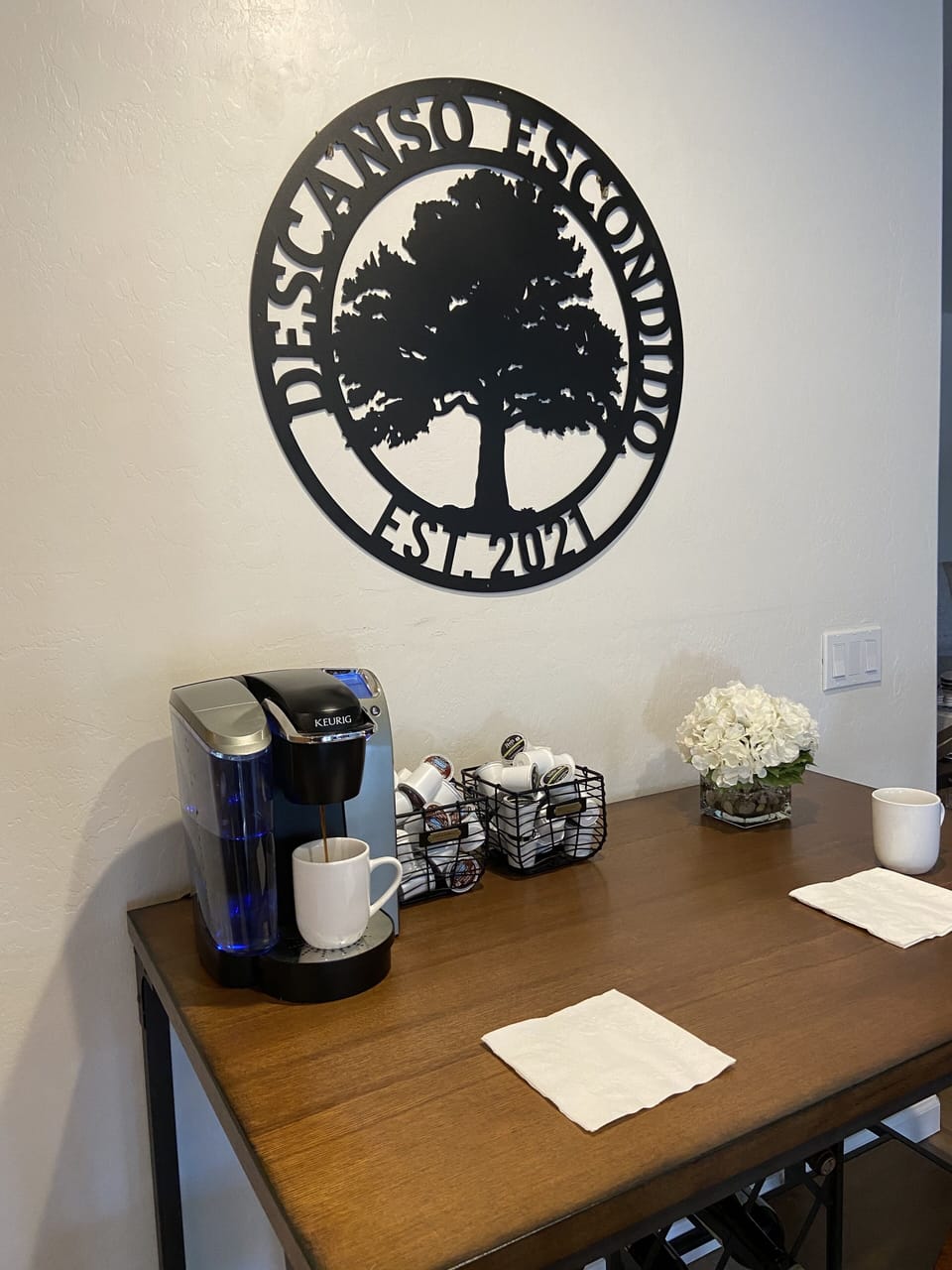 The coffee bar offers a Keurig, coffee, tea, sweeteners, and creamer. A dedicated faucet provides instant hot, filtered water—perfect for teatime anytime at Descanso Escondido.