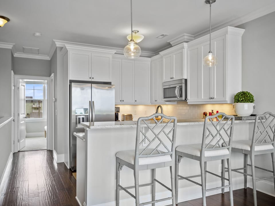 Fully-stocked, modern kitchen with a beautiful bar that seats 4