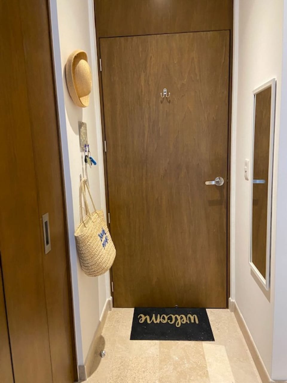 Entrance into condo keeps keys, hats,  purses, etc organized